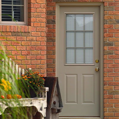 Grey entry door with large multi-pane window