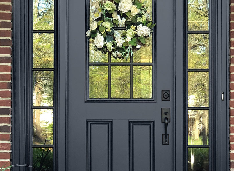 Front door in dark grey with black trimmed glass accents