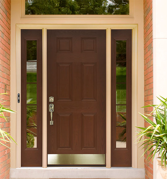 Brown wood front door with side and top glass panels